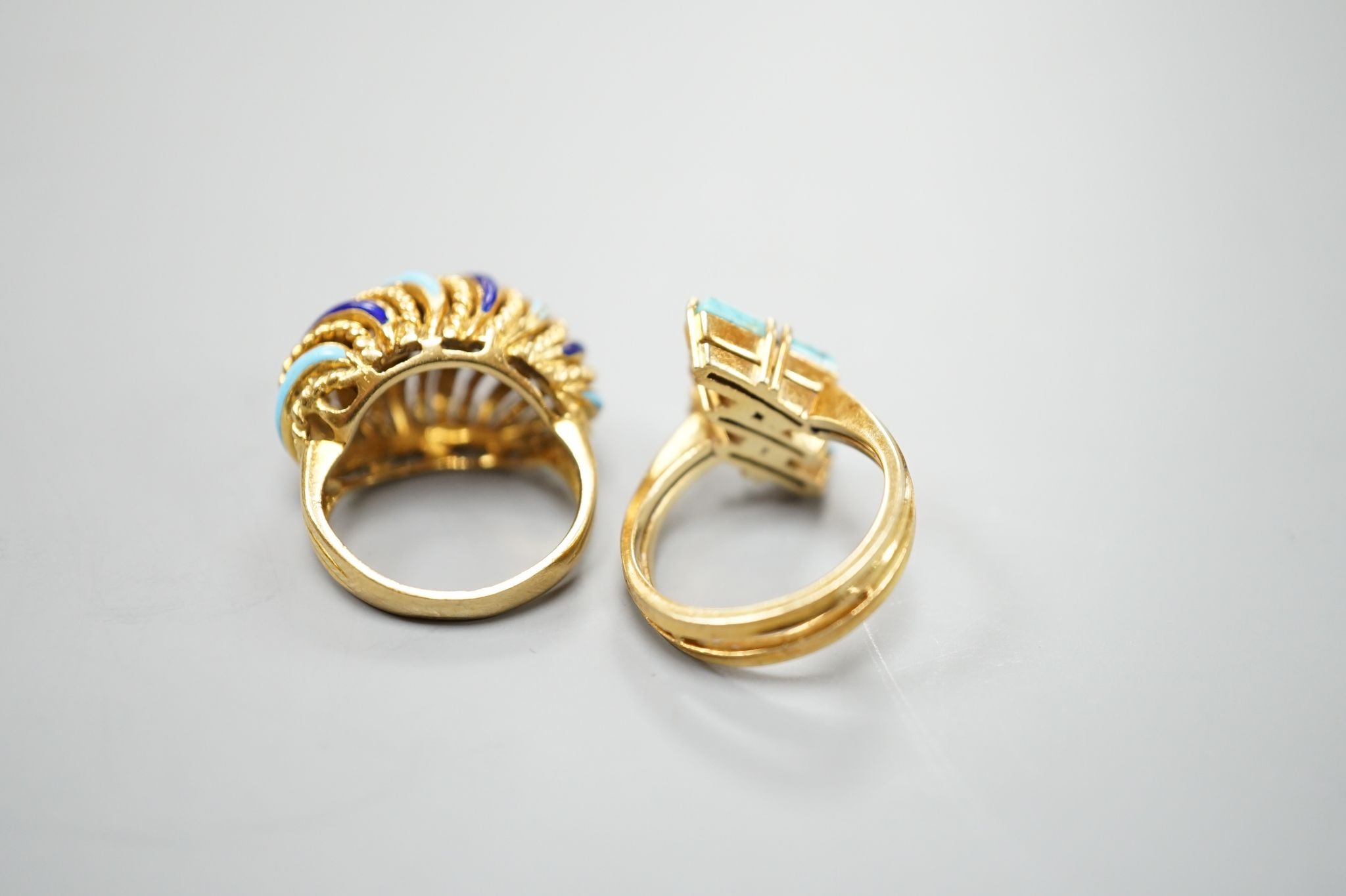 An Italian yellow metal and tow colour enamel set dress ring, size G/H and a yellow metal and three stone turquoise set modernist ring, gross 16 grams.